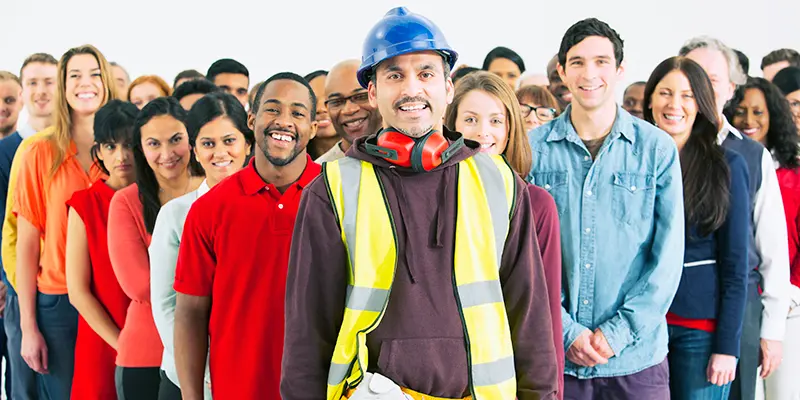 A confident construction worker and crowd